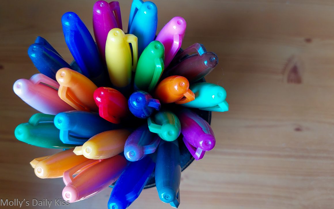Looking down into pot of colourful pens